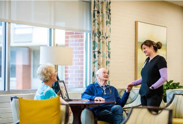 nurse holding resident's hand